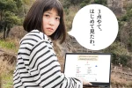 鯖くさらかし岩の近くでサイトを評価する女性